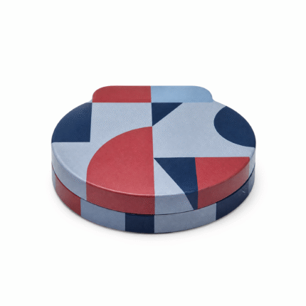 Custom printed round tin box with geometric pattern, closed on white background